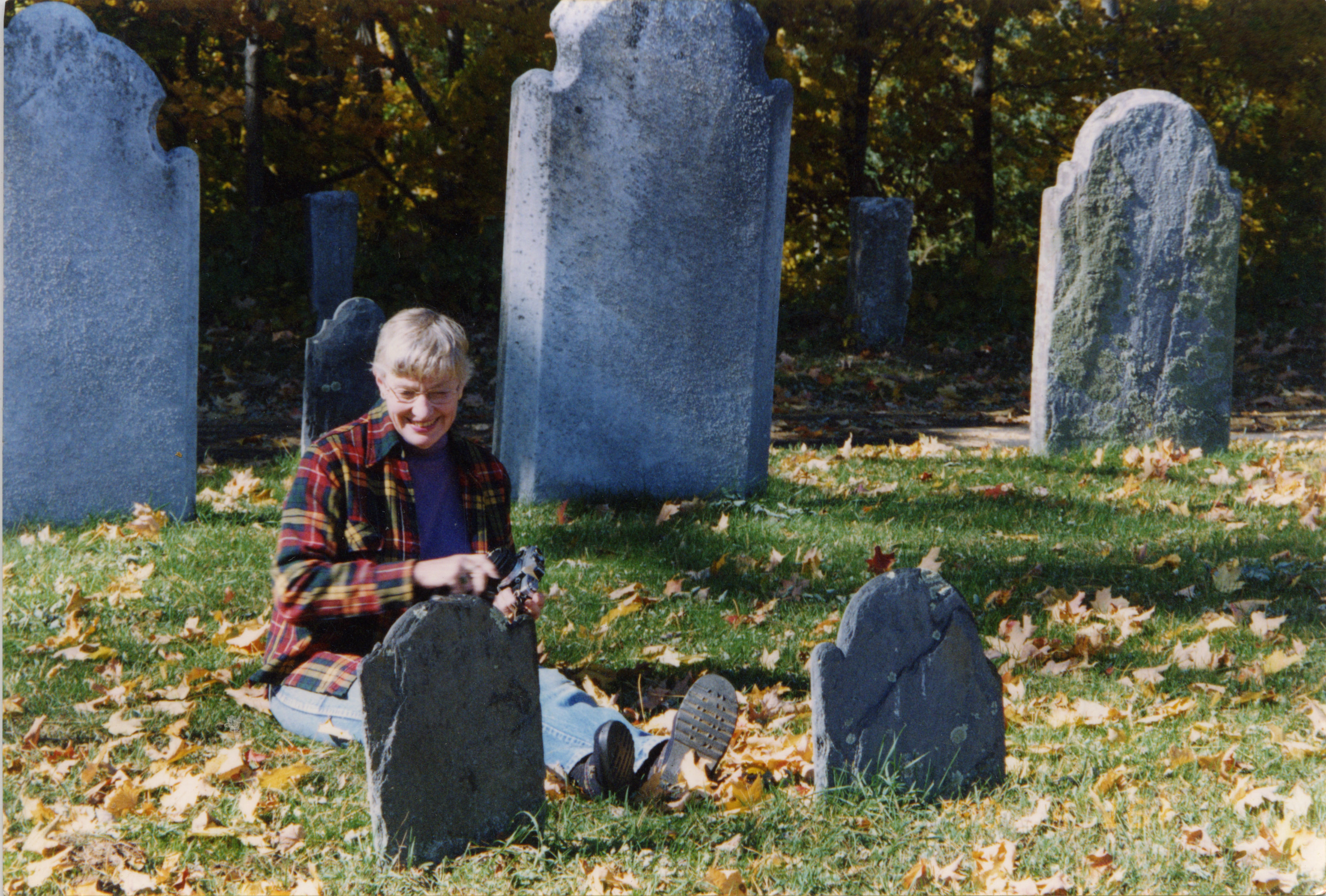 
An image of: Marie Ferre among the headstones, ca.2004