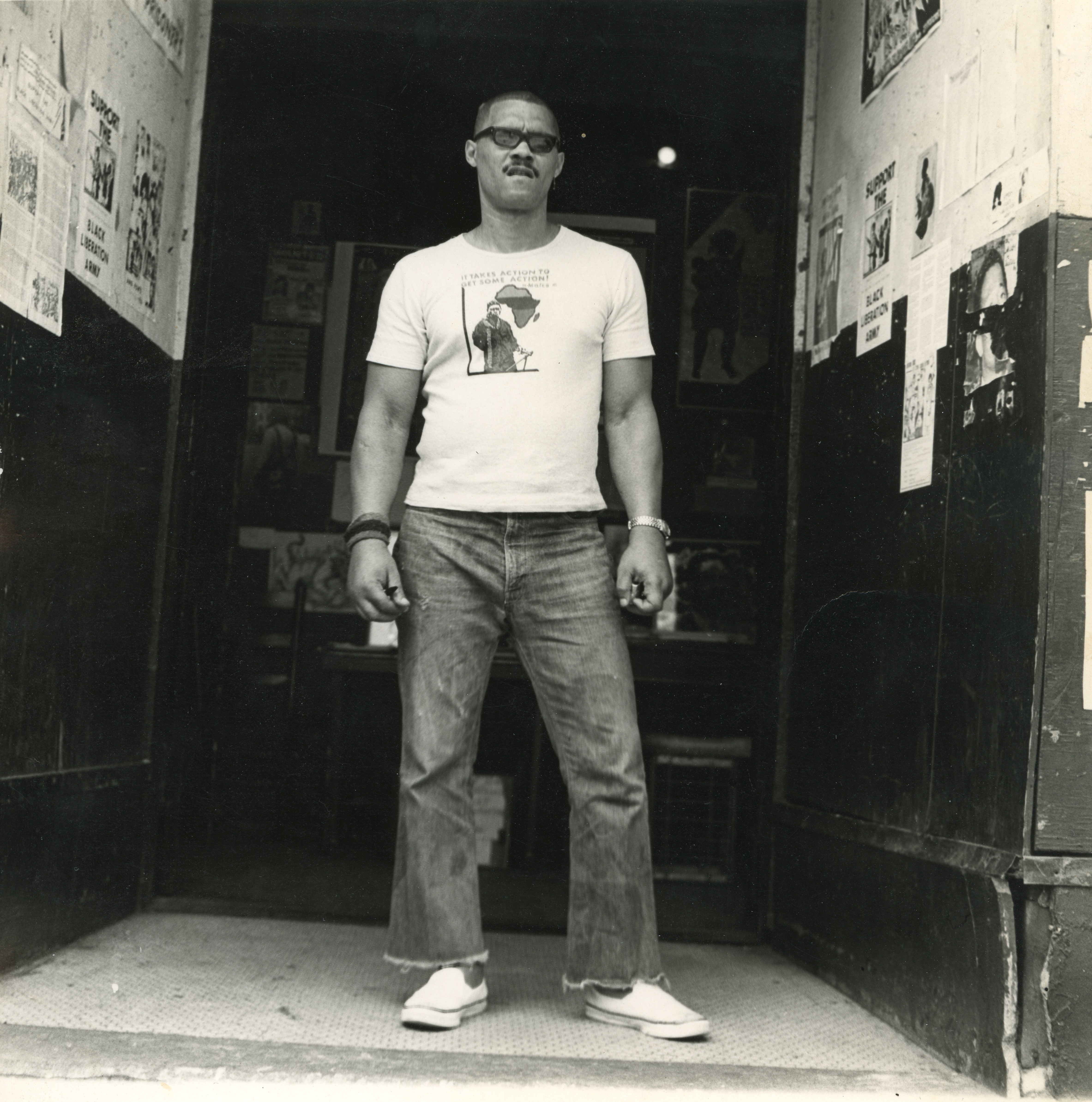 
An image of:  Frankie Ziths in front of the Black Panther Party Harlem Branch office, 1977. Photo by Kwesi Balagoon (with Ziths's camera).