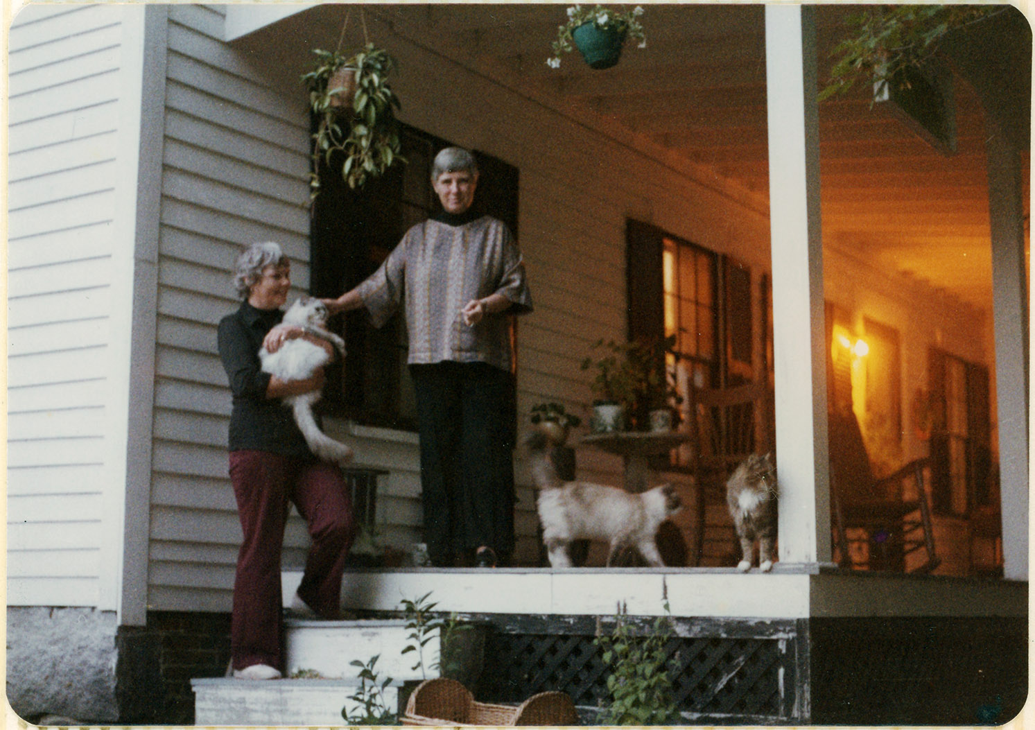 Depiction of Abramson, Johnson, and cats on the porch of their New Salem home, 1977