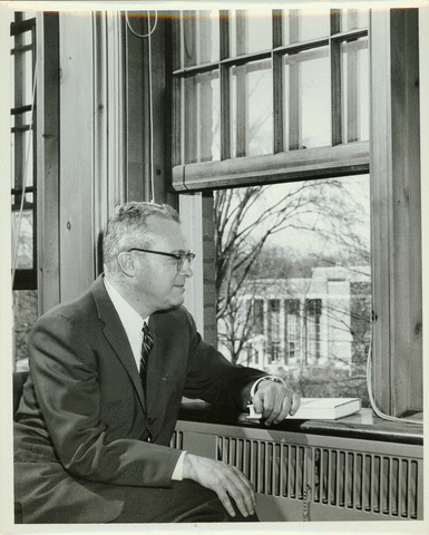 John W. Lederle looking out a window